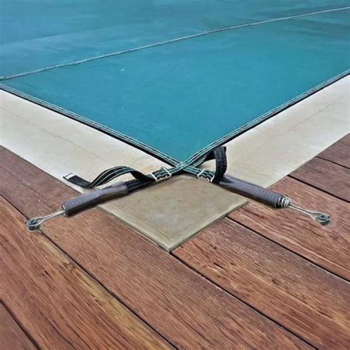 How are pool covers anchored