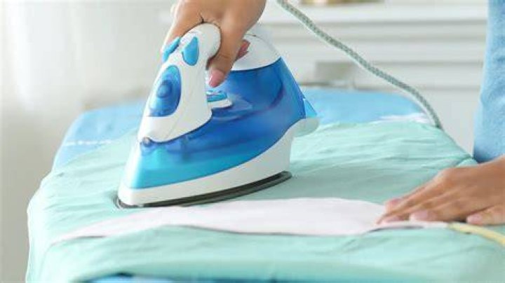 How do you iron a damp cloth